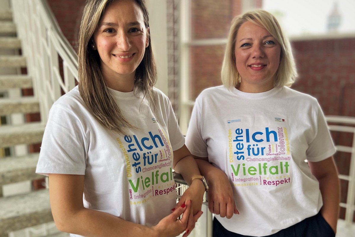Paula Bisiriyu (l.) und Milica Dacic von der Beratungsstelle für die ehrenamtliche Flüchtlingshilfe tragen die T-Shirts „Ich stehe für Vielfalt“, die kostenlos auf dem „Fest der Kulturen“ in Heide verteilt werden.